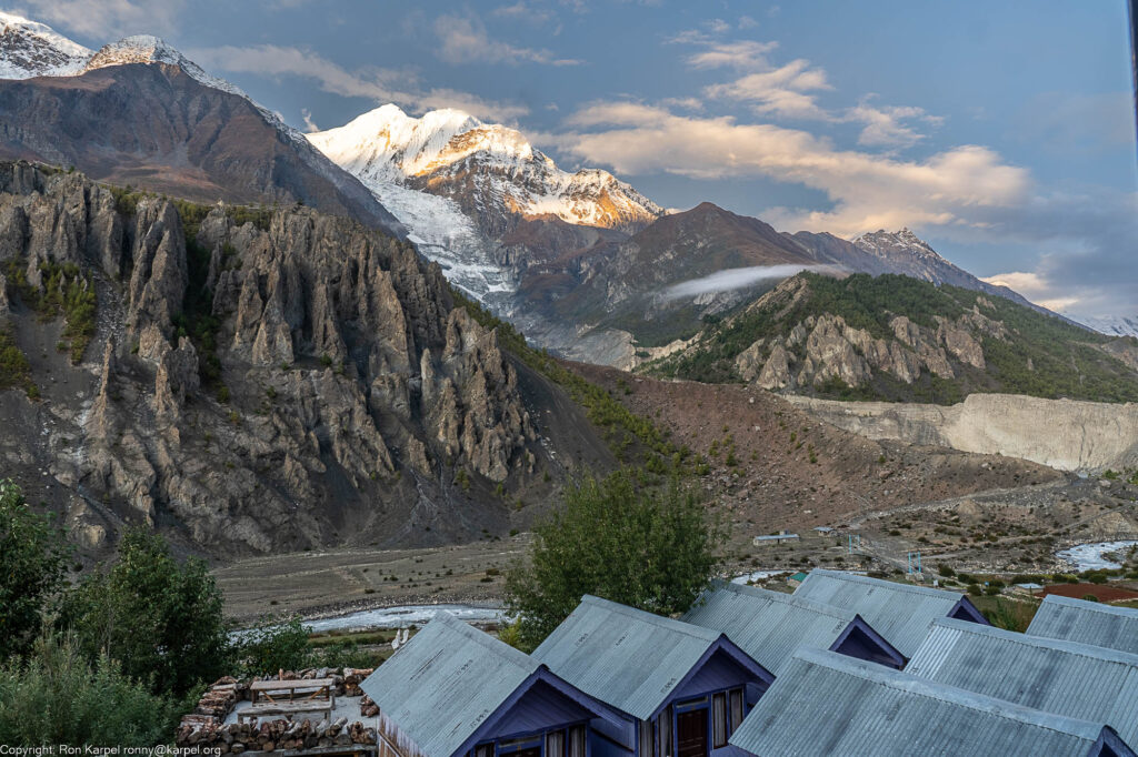 A view of a snow capped mountain and cabbins