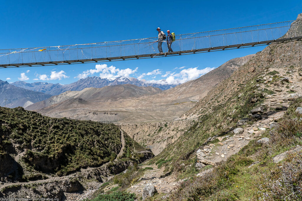 Hikers on a high suspension bridge